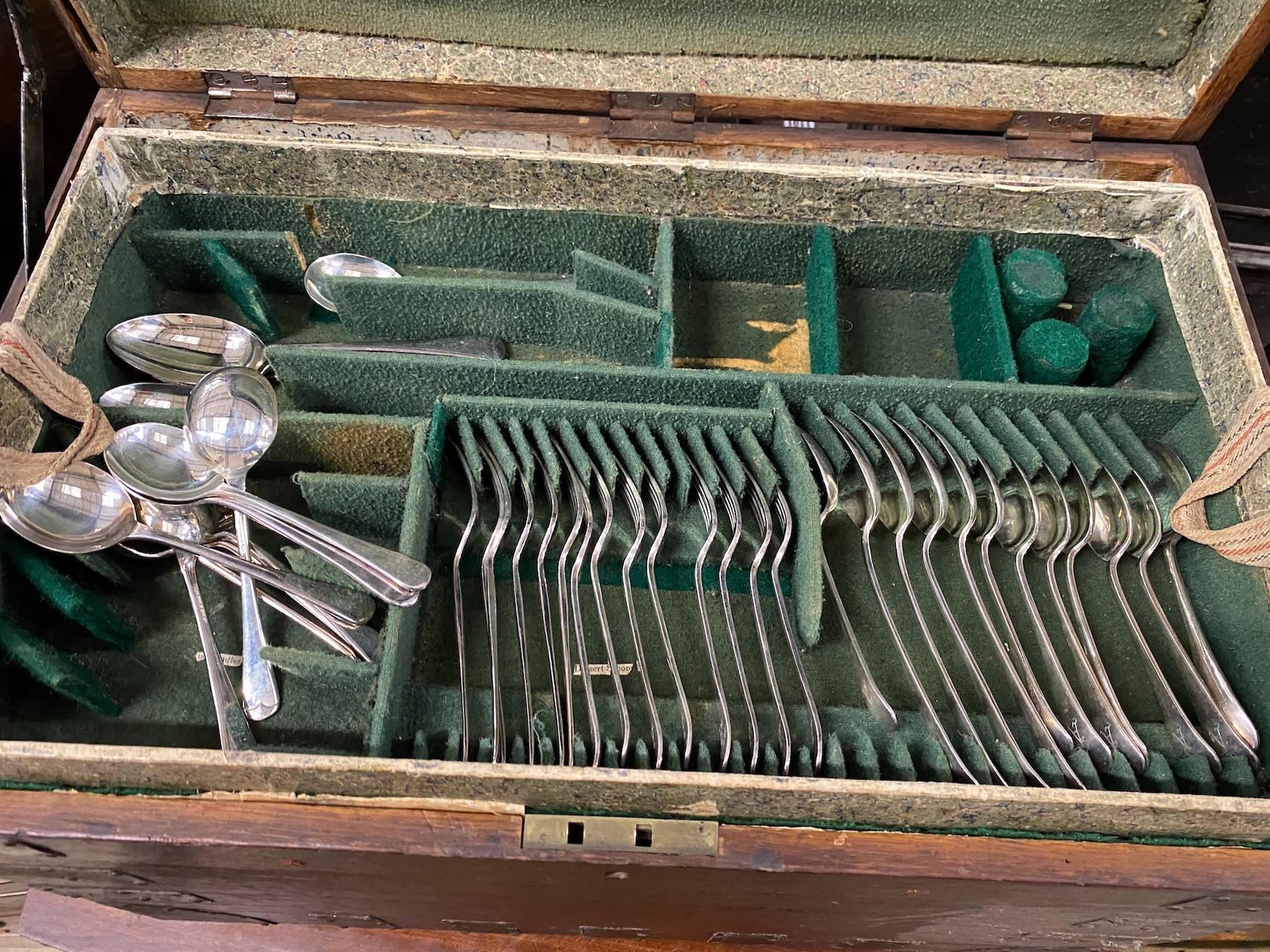 A Victorian iron bound oak silver chest with three interior trays housing assorted silver plated flatware, width 64cm, depth 41cm, height 51cm